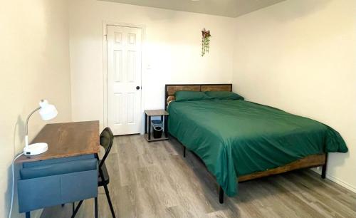 a bedroom with a bed and a table and a desk at Private room near downtown dallas9 in Dallas