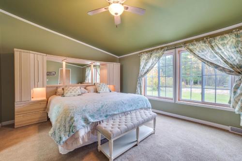 a bedroom with a bed and a large window at Spacious De Tour Village Home Near Lake Huron! in De Tour Village