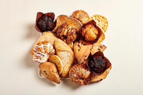 a pile of different types of pastries on a plate at Holiday Inn Houston S - NRG Area - Med Ctr by IHG in Houston