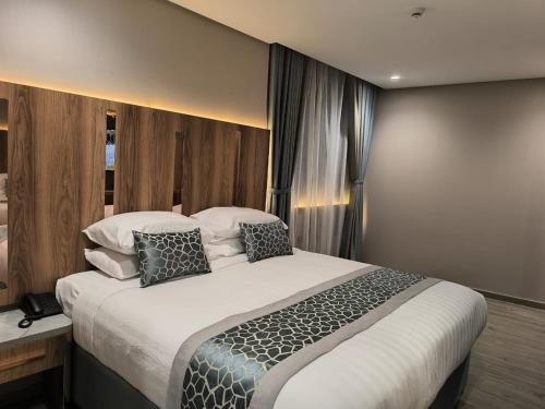 Postel nebo postele na pokoji v ubytování فندق نسمات مكةNasamat Makkah Hotel