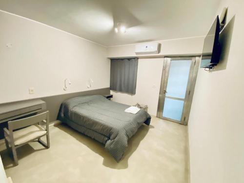 a bedroom with a bed and a television in it at ALWA Suites in Resistencia