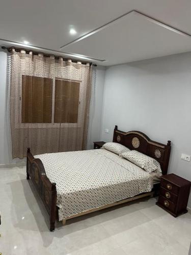 a bedroom with a bed and a window at Apartamento Nador AlJadid 2 in Nador
