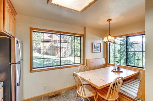 a kitchen with a table and chairs and a refrigerator at Deck with Mountain Views Cabin in Bear Valley! in Bear Valley