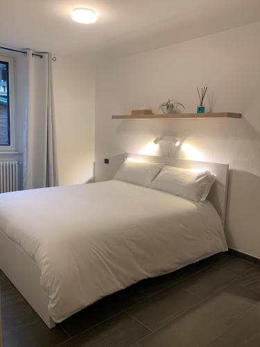 a bedroom with a white bed with a light on it at Spazio Perlasca Apt 1 - Cernobbio Como Lake in Cernobbio