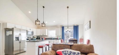 a living room with a couch and a kitchen at Solymar in Colonial Beach