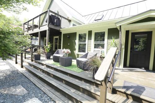 a house with a deck with furniture on it at Stay At Jimmy's in Woodstock