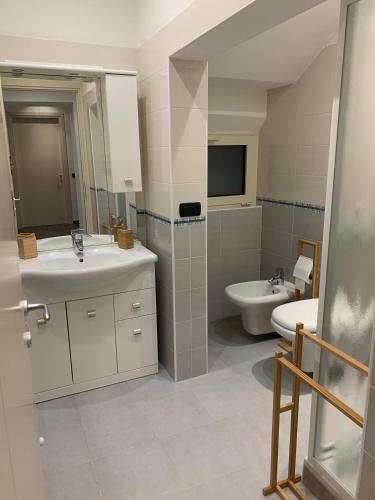 a bathroom with a sink and a toilet and a mirror at Spazio Perlasca Apt 1 - Cernobbio Como Lake in Cernobbio