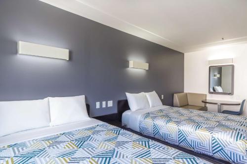 a hotel room with two beds and a mirror at Motel 6-Laredo, TX - Airport in Laredo