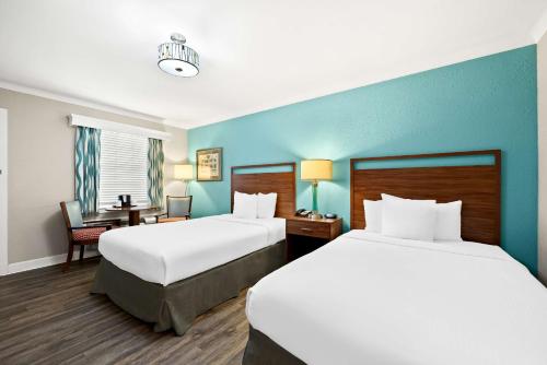 a hotel room with two beds and a desk at Best Western Route 66 Rail Haven in Springfield