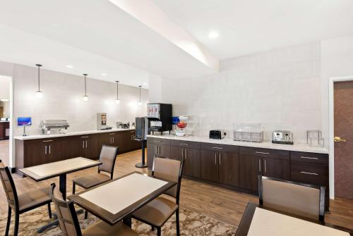 a room with tables and chairs and a kitchen at Best Western Palmyra Inn & Suites in Palmyra