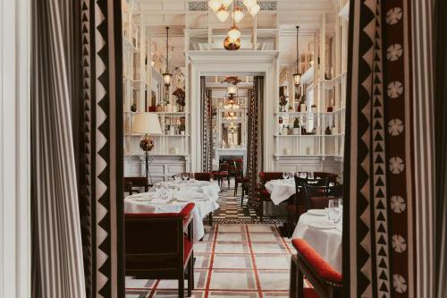 a restaurant with tables and chairs in a room at At Sloane in London