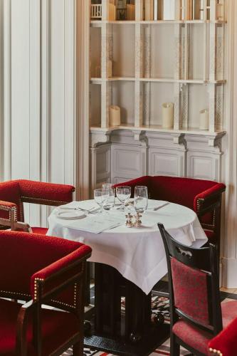 a dining room with a table with wine glasses on it at At Sloane in London