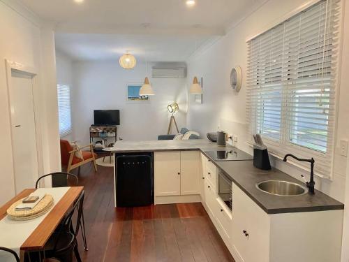 a kitchen with a sink and a counter top at Yaringa Cottage by the sea in Busselton