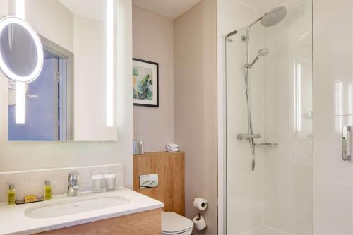 a bathroom with a sink and a shower at DoubleTree by Hilton London Chelsea in London