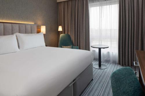 a hotel room with a bed and a window at DoubleTree by Hilton London Chelsea in London