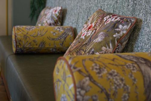a group of pillows sitting on top of a couch at DoubleTree by Hilton London Chelsea in London