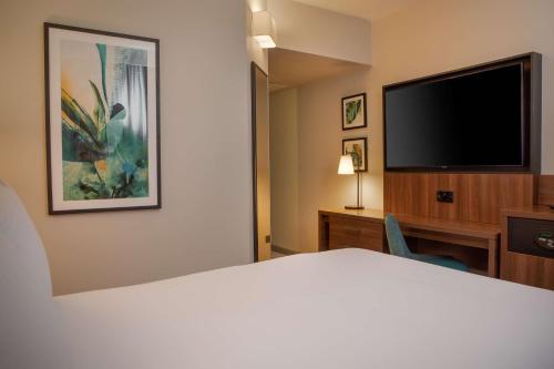 a hotel room with a bed and a flat screen tv at DoubleTree by Hilton London Chelsea in London