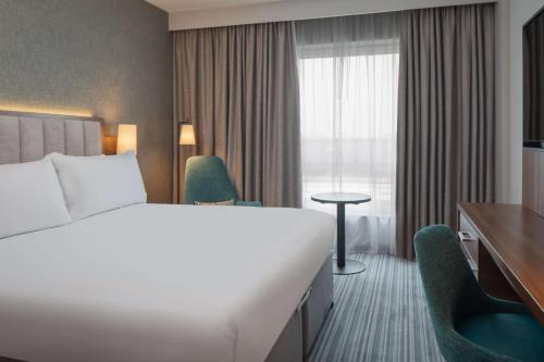 a hotel room with a bed and a window at DoubleTree by Hilton London Chelsea in London