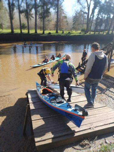 a group of people preparing their kayaks on a dock at Viva el Delta in Tigre