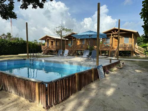 a house with a swimming pool in front of it at Tuquil-HA in Ladyville