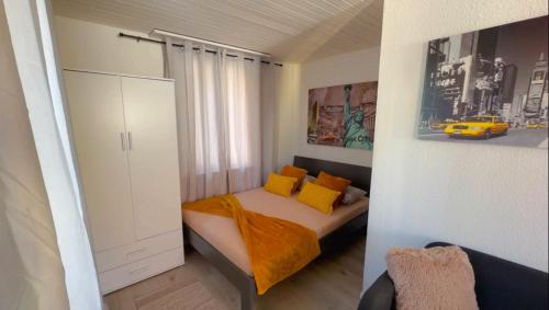 a bedroom with a bed with yellow pillows at Grandhouse center of Switzerland in Olten