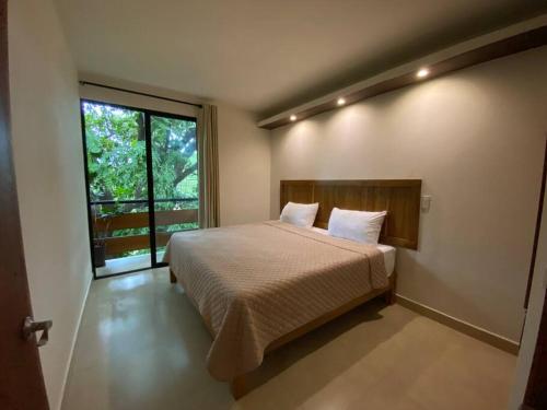 Ένα ή περισσότερα κρεβάτια σε δωμάτιο στο Casa SaQua Residencia Palenque