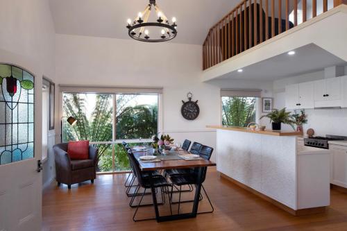 a kitchen and dining room with a table and chairs at Aggies Way - dog friendly with panoramic views in Daylesford