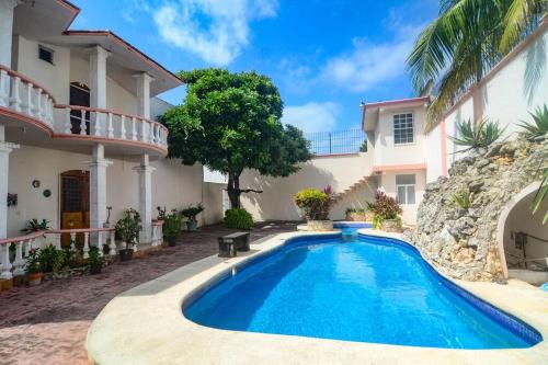 a swimming pool in front of a house at Casa con alberca y amplio espacio para tu familia in Playa del Carmen
