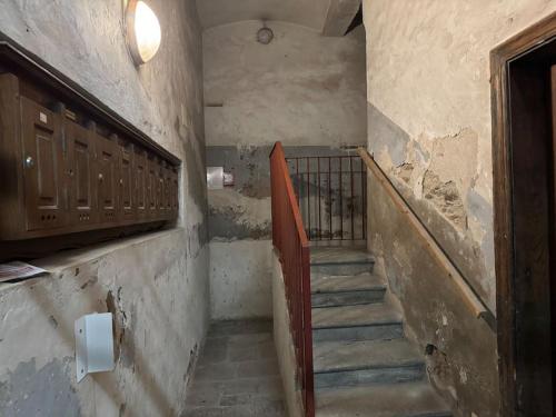 a staircase in a room with a door and a stair railing at Suite Pascal by Monarca Business and Holidays - Bastia in Bastia