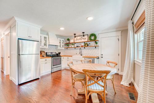 a kitchen with a table and chairs and a refrigerator at Family-Friendly Harrison Home 33 Mi to Branson! in Harrison