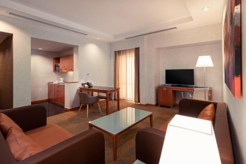 a living room with a couch and a table at Holiday Inn Kuwait by IHG in Kuwait
