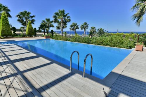 a swimming pool with a view of the ocean at Sunset Villa in Saronida
