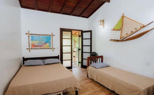 Ένα ή περισσότερα κρεβάτια σε δωμάτιο στο Residencial Canto da Praia - Jureia 30mts da praia