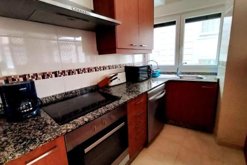 a kitchen with a sink and a counter top at Apto Cedeira a 3 mins playa in Cedeira