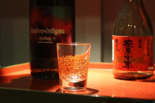 a glass of champagne next to a bottle of wine at Rockwood Hotel & Spa in Ajigasawa
