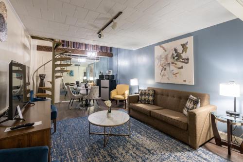 a living room with a couch and a table at Altoona Grand Hotel in Altoona