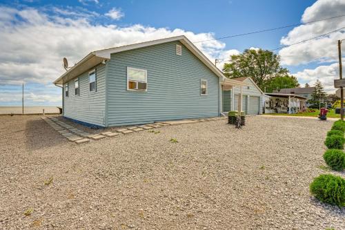 a blue house sitting on top of a gravel yard at Serene Lakefront Standish Home with Fire Pit and Grill in Standish