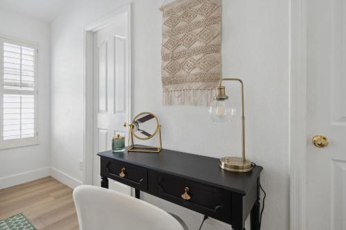 a black desk with a mirror and a chair at Chic Desert Retreat - Lush Spa Pool - Mini Golf in Phoenix