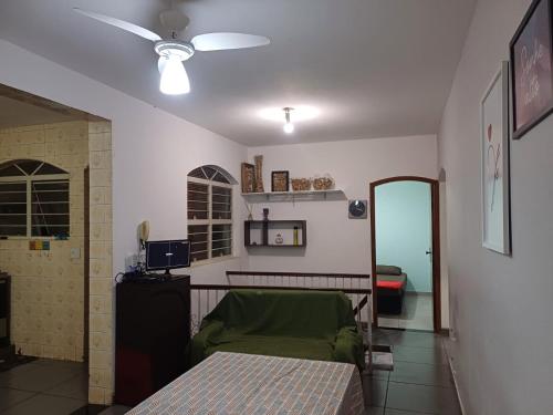a bedroom with a bed and a ceiling fan at Jardim Santa Rosália in Sorocaba