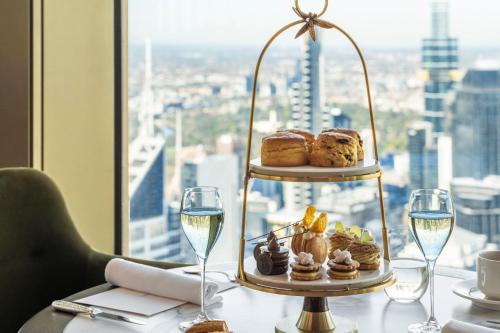 a table with a plate of pastries and glasses of wine at The Ritz-Carlton, Melbourne in Melbourne