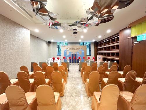 a conference room with chairs and a stage in the background at Hi-YES Hotel Hualien in Hualien City