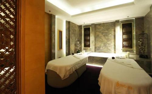 a bedroom with two beds with white sheets at Shanghai Marriott Marquis City Centre in Shanghai