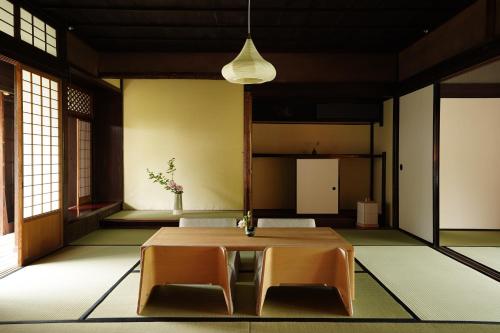 a dining room with a table and two chairs at NIPPONIA HARIMA FUKUSAKI ZOUSHONO YAKATA in Fukusaki