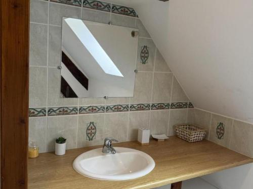 a bathroom with a sink and a mirror at Maison de ferme restaurée avec mini ferme, terrasse et grand jardin près de la Vallée du Cher - FR-1-489-270 in Le Cluzeau