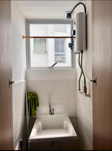 a bathroom with a sink and a window at Confortable apartaestudio in Manizales