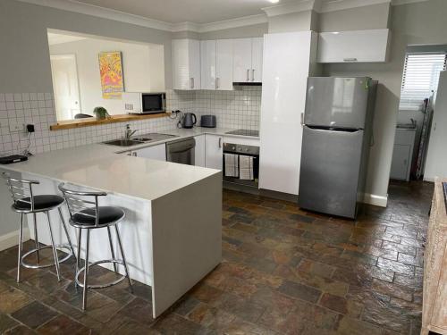 a kitchen with a counter and a refrigerator at Stylishly renovated bungalow in Orange