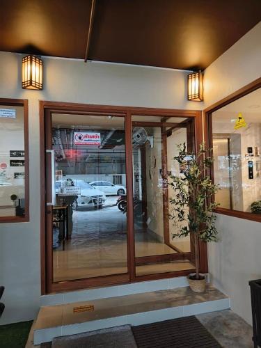 a store front with glass doors and a potted plant at SNOW HOUSE Buriram in Buriram