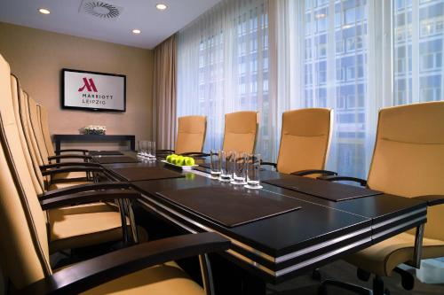 a conference room with a long table and chairs at Leipzig Marriott Hotel in Leipzig