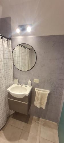 a bathroom with a sink and a mirror at Duplex Portugal Tw in Trelew