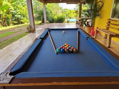a pool table with balls on a patio at Casa de campo (chácara) em Louveira in Louveira